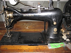 Black, Singer 7-class, sewing machine. Comes with its own large sewing table.